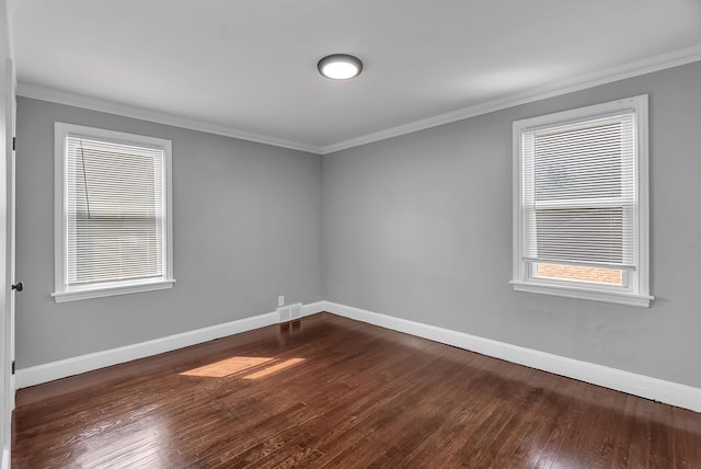 8790 E Outer Dr, Detroit, MI 48213 - unfurnished room featuring dark wood-type flooring, visible vents, and crown molding