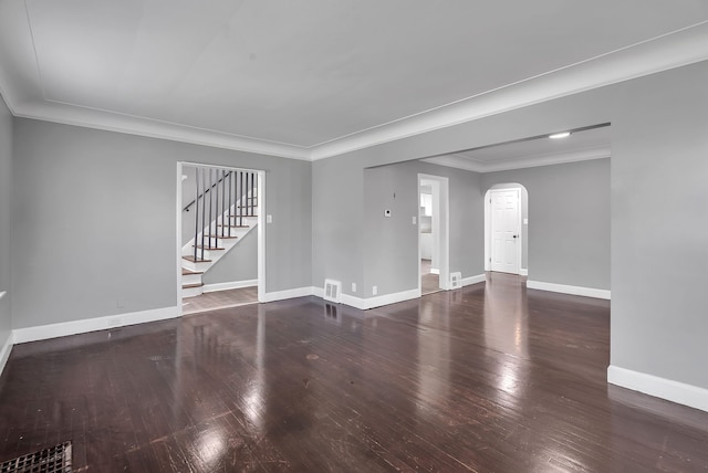 8790 E Outer Dr, Detroit, MI 48213 - unfurnished living room featuring baseboards, arched walkways, ornamental molding, and wood finished floors