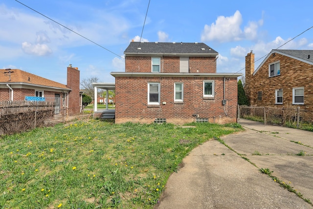 8790 E Outer Dr, Detroit, MI 48213 - back of property with fence, a lawn, and brick siding