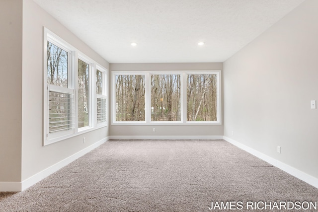 unfurnished room with recessed lighting, carpet flooring, and baseboards