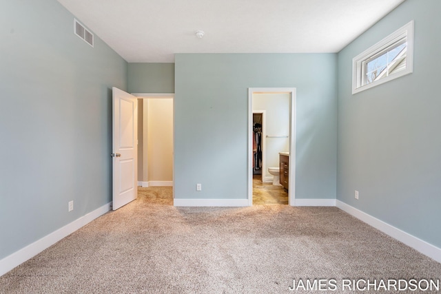 unfurnished bedroom featuring visible vents, carpet floors, and baseboards