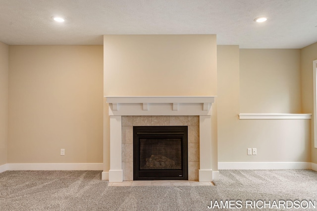 room details featuring a tiled fireplace, recessed lighting, and carpet floors