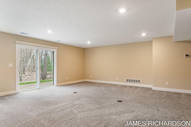 carpeted empty room with visible vents, recessed lighting, and baseboards