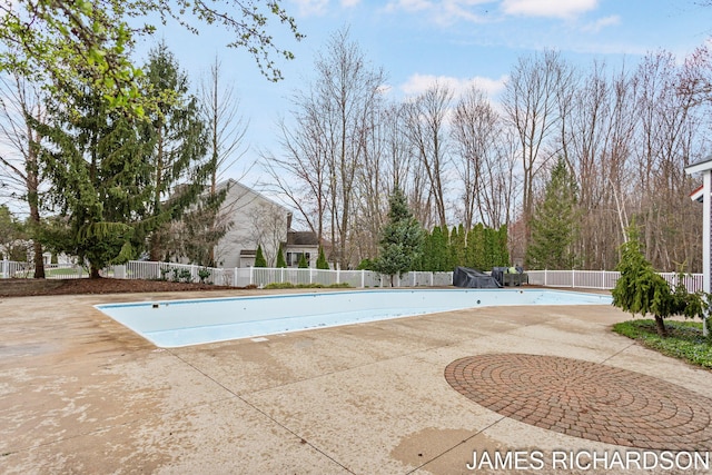 view of swimming pool with a fenced in pool, a patio area, and fence