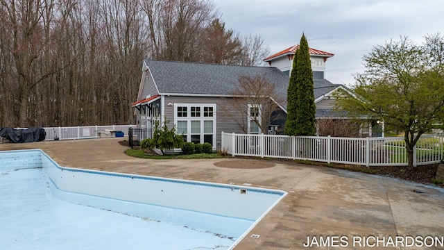view of swimming pool featuring a fenced in pool, a patio area, and fence