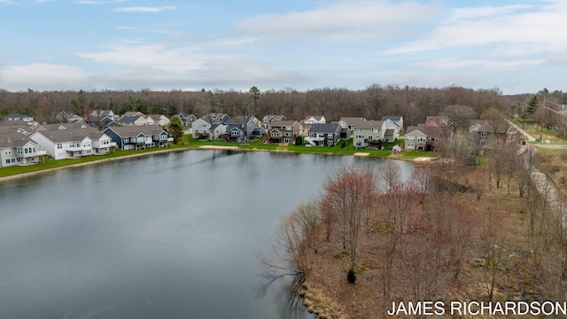aerial view with a water view and a residential view