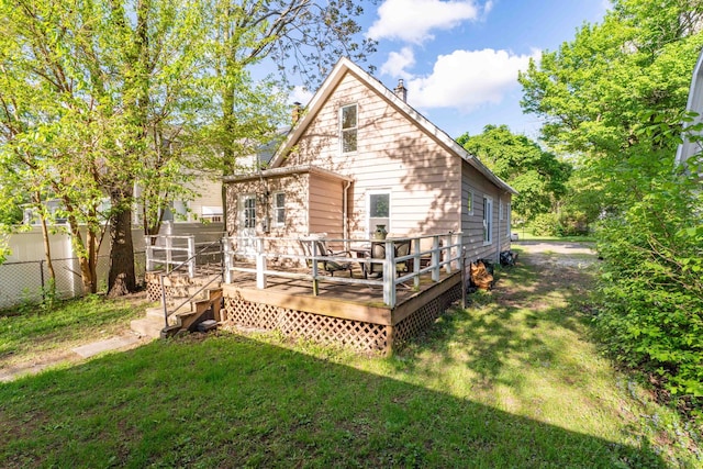 rear view of property featuring a deck and a chimney