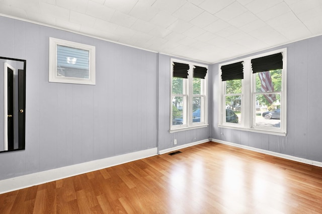 empty room with wood finished floors and baseboards