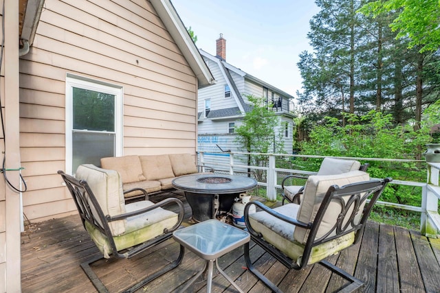wooden deck with an outdoor fire pit
