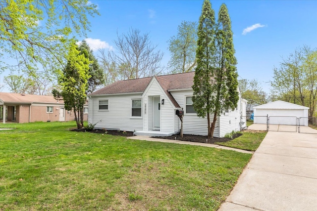 bungalow-style home with a front lawn, fence, a gate, an outbuilding, and a detached garage