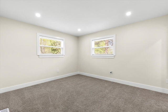 carpeted empty room featuring baseboards and recessed lighting