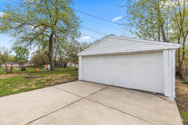detached garage featuring fence