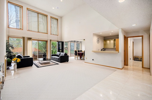 tiled living area with baseboards, a high ceiling, carpet flooring, and recessed lighting