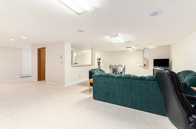 living area featuring baseboards and recessed lighting