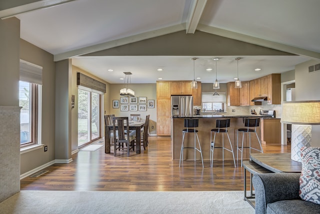 living area featuring visible vents, dark wood finished floors, and a wealth of natural light