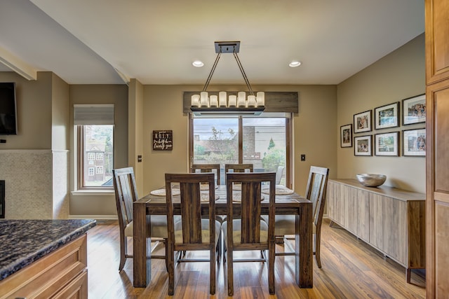 dining space featuring recessed lighting, an inviting chandelier, and wood finished floors