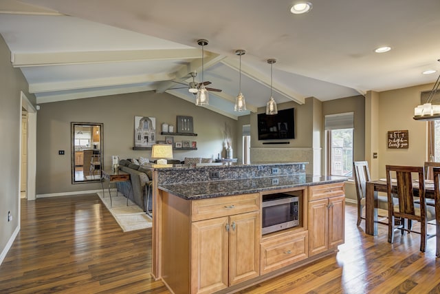 kitchen featuring a ceiling fan, stainless steel microwave, recessed lighting, vaulted ceiling with beams, and dark wood-type flooring