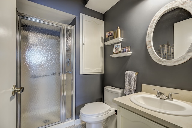 bathroom featuring vanity, tile patterned flooring, toilet, and a shower stall