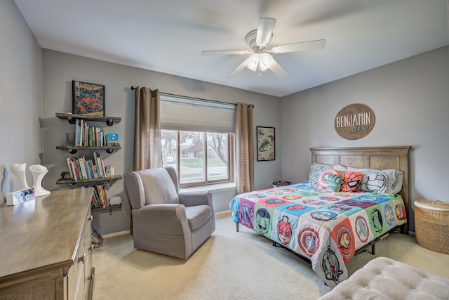 bedroom with light colored carpet, baseboards, and ceiling fan