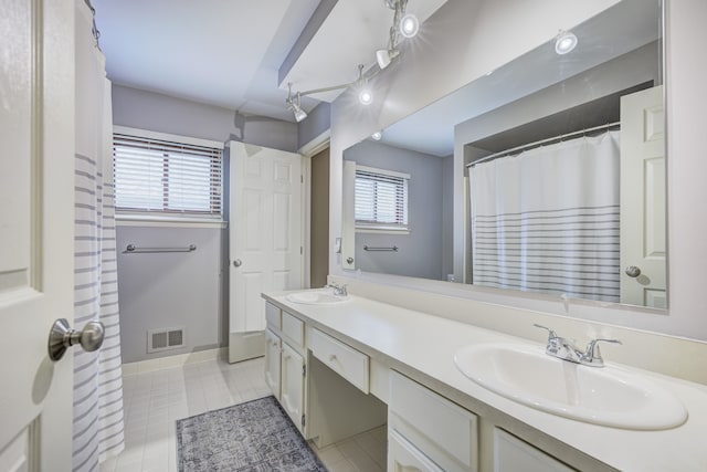 bathroom featuring a sink, a wealth of natural light, and visible vents