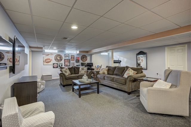 carpeted living room featuring visible vents and a paneled ceiling