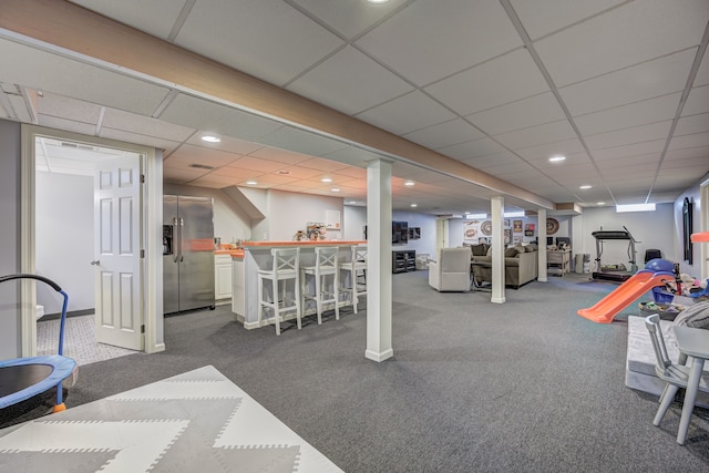 workout area with recessed lighting, carpet flooring, a drop ceiling, and bar area
