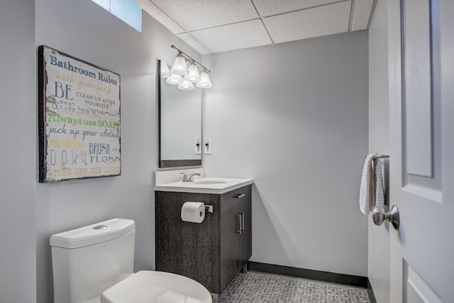bathroom with toilet, tile patterned floors, a paneled ceiling, and vanity