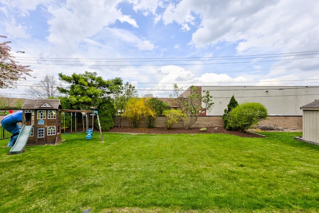 view of yard featuring a playground and fence