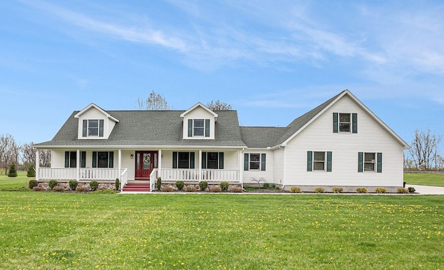 cape cod-style house with covered porch, roof with shingles, and a front yard