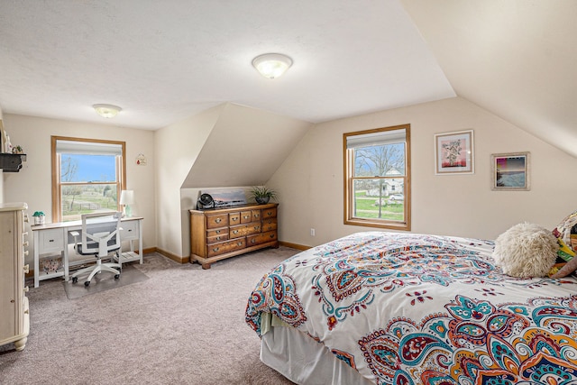 bedroom with carpet floors, baseboards, multiple windows, and lofted ceiling