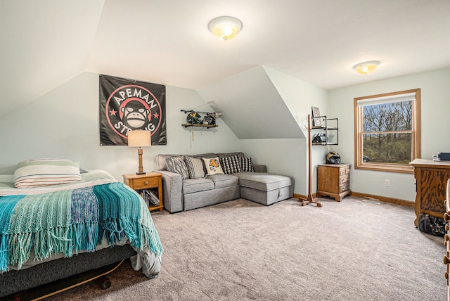 carpeted bedroom with baseboards and vaulted ceiling