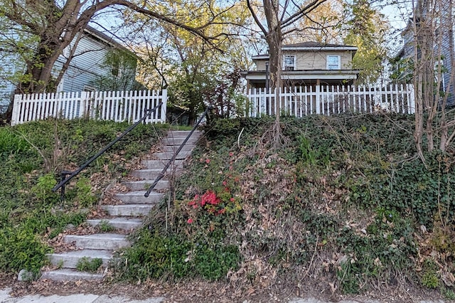 view of yard featuring stairway and fence
