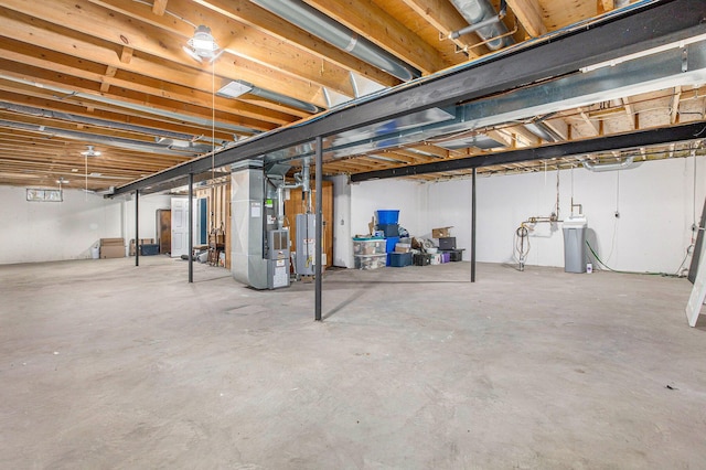 unfinished basement with gas water heater and heating unit