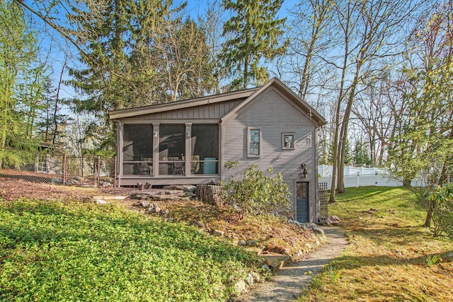 350 Ferry St, Douglas, MI 49406 - view of home's exterior featuring fence, a yard, and a sunroom