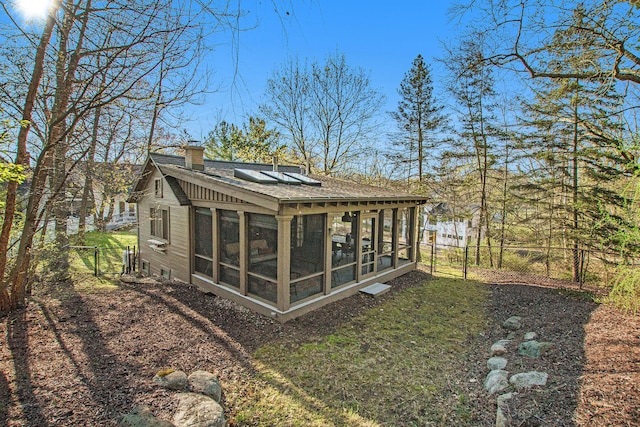 350 Ferry St, Douglas, MI 49406 - back of house featuring a chimney, fence, and roof with shingles