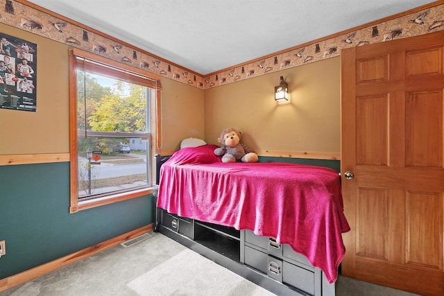 320 Marble St, Cadillac, MI 49601 - bedroom with carpet floors, baseboards, visible vents, and crown molding