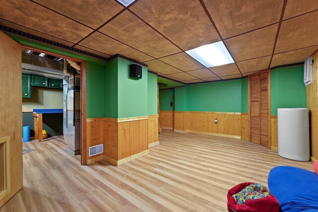 320 Marble St, Cadillac, MI 49601 - finished below grade area with visible vents, wood walls, wainscoting, wood finished floors, and baseboards
