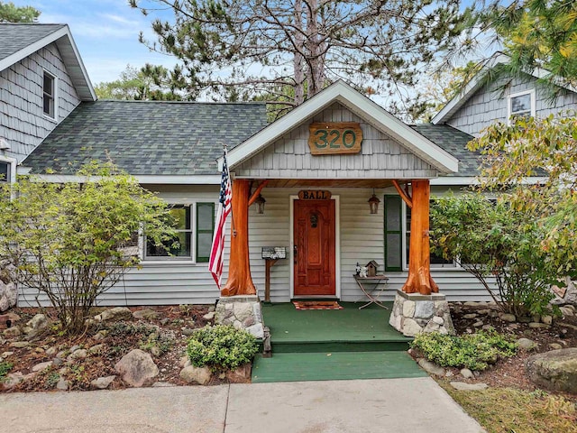 320 Marble St, Cadillac, MI 49601 - bungalow-style home featuring a porch and a shingled roof