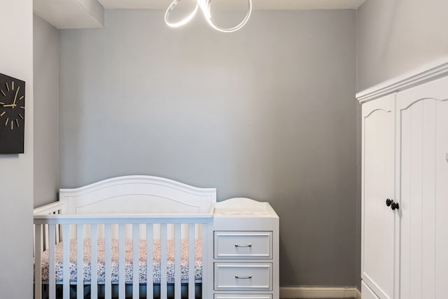 15 Kirby St Unit 826, Detroit, MI 48202 - bedroom featuring a nursery area, a chandelier, and wainscoting