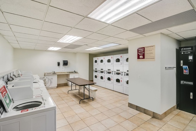 15 Kirby St Unit 826, Detroit, MI 48202 - common laundry area with stacked washer / dryer, light tile patterned flooring, baseboards, and washer and dryer