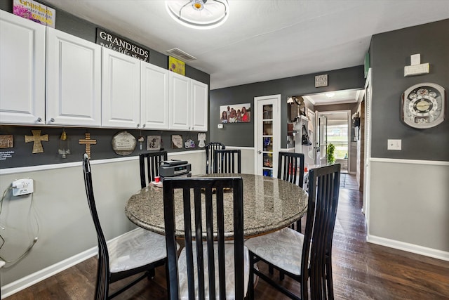 dining space featuring baseboards, dark wood-style flooring, and visible vents
