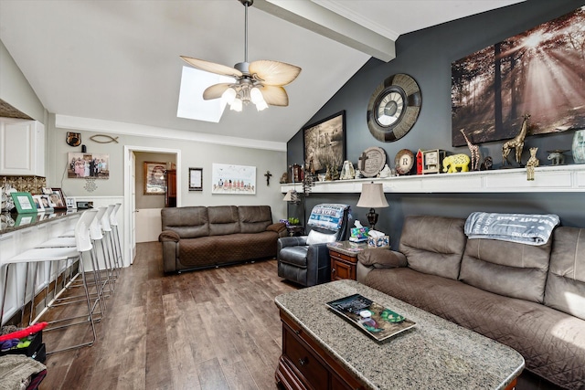 living room featuring ceiling fan, wood finished floors, and lofted ceiling with skylight