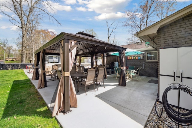 view of patio featuring a gazebo and outdoor dining space