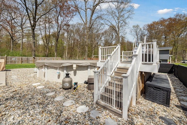 exterior space with stairway, fence, a fenced in pool, and a wooden deck
