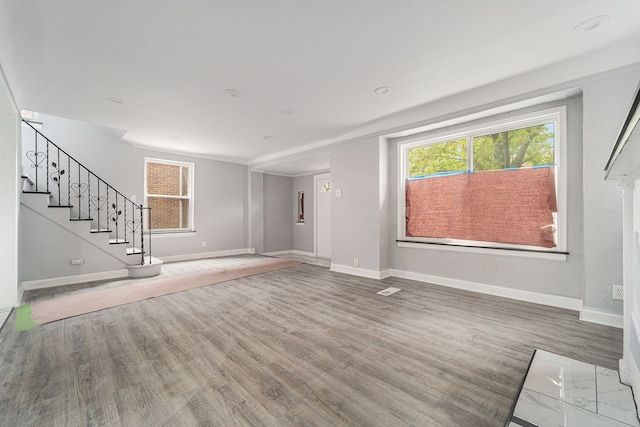 16140 Monte Vista St, Detroit, MI 48221 - unfurnished living room with wood finished floors, baseboards, and healthy amount of natural light