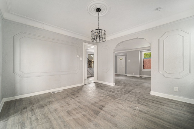 16140 Monte Vista St, Detroit, MI 48221 - unfurnished dining area with arched walkways, stairway, baseboards, wood finished floors, and ornamental molding