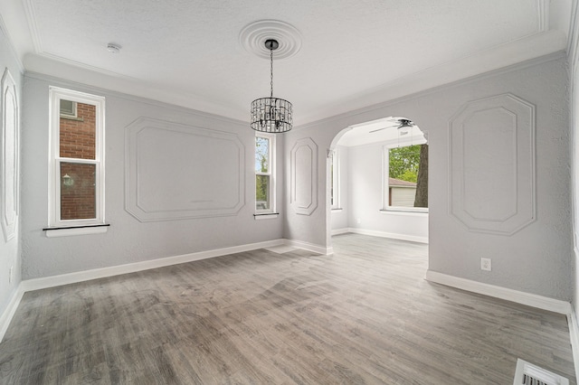 16140 Monte Vista St, Detroit, MI 48221 - unfurnished room with crown molding, wood finished floors, baseboards, arched walkways, and a chandelier