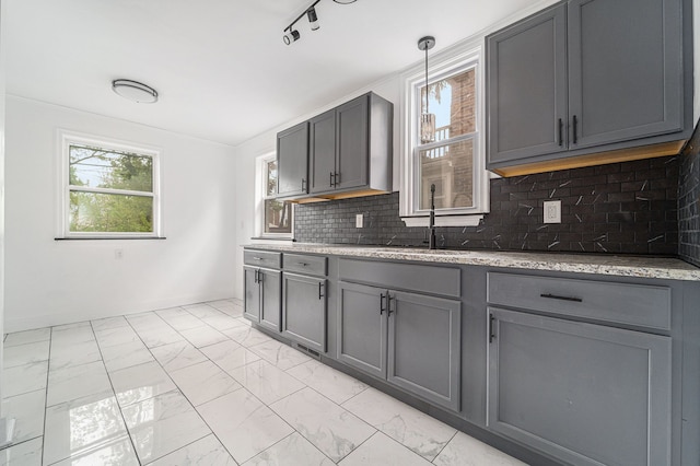 16140 Monte Vista St, Detroit, MI 48221 - kitchen featuring light marble finish floors, gray cabinets, a sink, and light stone counters