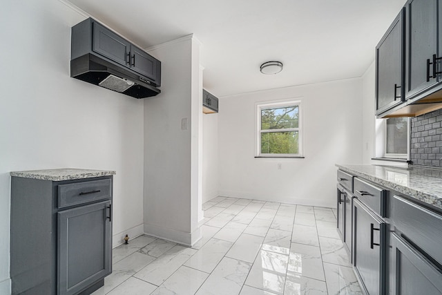 16140 Monte Vista St, Detroit, MI 48221 - kitchen featuring light marble finish flooring, light stone countertops, baseboards, decorative backsplash, and gray cabinetry