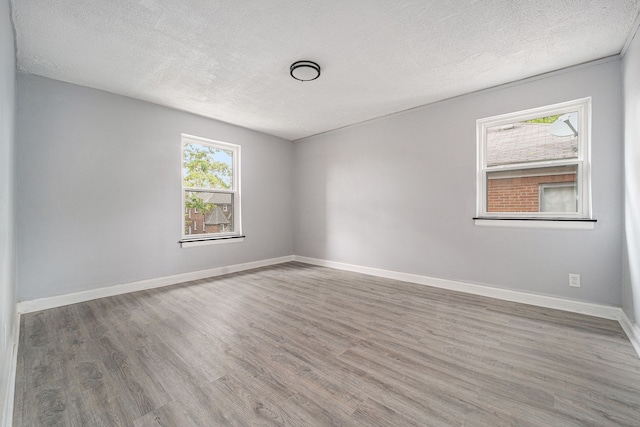16140 Monte Vista St, Detroit, MI 48221 - spare room featuring a textured ceiling, wood finished floors, and baseboards